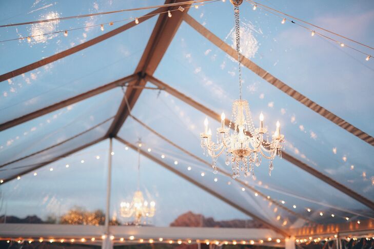 Chandeliers are an unexpected decor element in the outdoor tent.