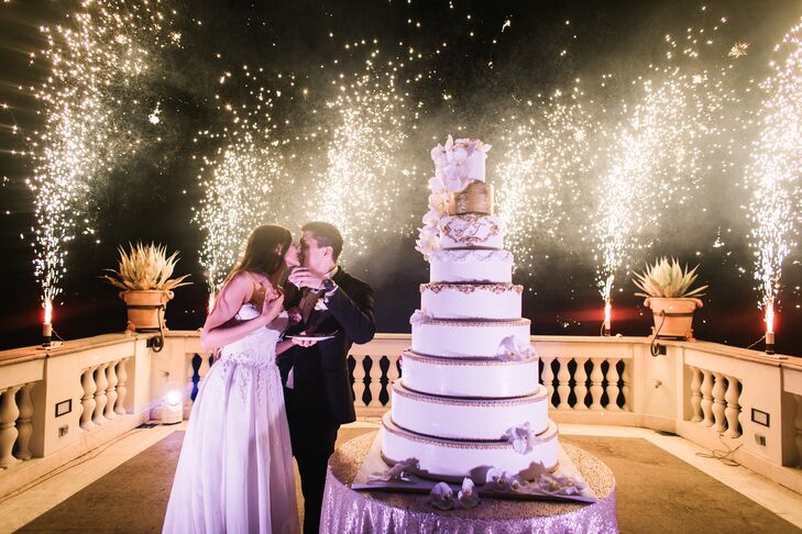 After indulging in a mouthwatering four-course meal, the newlyweds ushered their guests up onto Villa Miani’s terrace. With the twinkling lights of Rome as their backdrop, the couple cut their colossal nine-layer cake as sparklers lit up the sky with sparkling light.