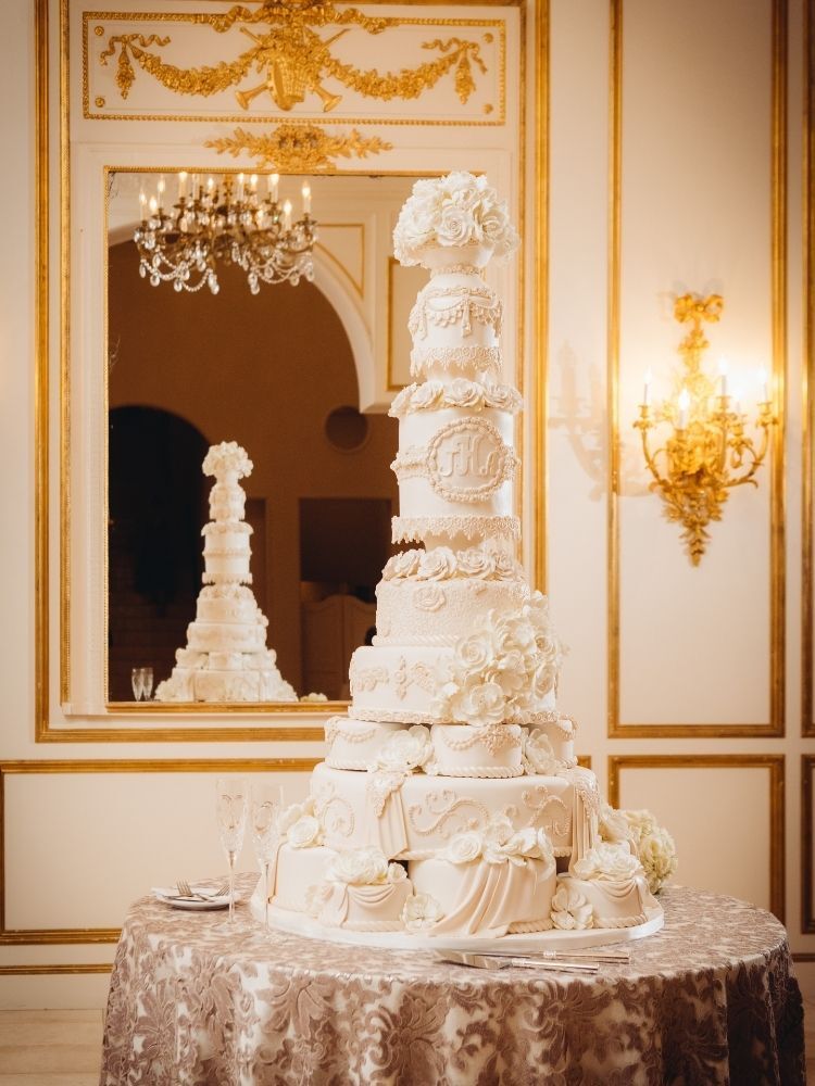 dramatic towering white wedding cake with intricate piping