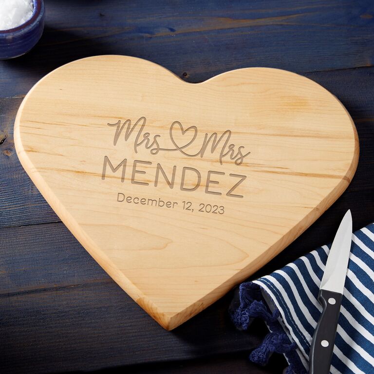 Mrs. and Mrs. heart-shaped cutting board by Personalization Mall. 