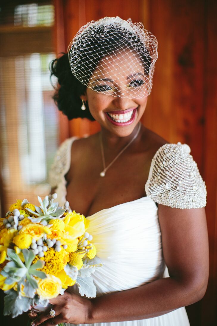 Charita decided on a flowy vintage-inspired dress that was airy enough for her beach locale yet still felt formal. She completed her Gatsby-esque look with a birdcage veil and an embellished headband that matched her beaded cap sleeves.