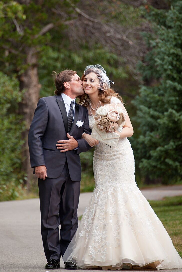 To find the perfect wedding dress, Melissa visited Amanda’s Bridal in Arvada, Colorado. It was there that she found a beautifully embellished design by Mori Lee in a mermaid silhouette that perfectly complemented her hourglass shape. And though she had originally had her heart set on a keyhole back, she couldn’t resist the fun vibe of the gown’s strapless neckline. To give her the best of both worlds, Melissa’s consultant was able to find a shawl that she could wear during the ceremony.