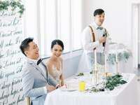 Bride and groom laughing during wedding toast