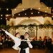 Grooms in Matching White Tux Jackets Performing Their First Dance With a Lift