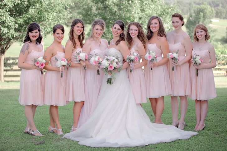 The bridesmaids wore short strapless blush dresses with bouquets of pink and white blooms. Silver strappy shoes completed their looks.