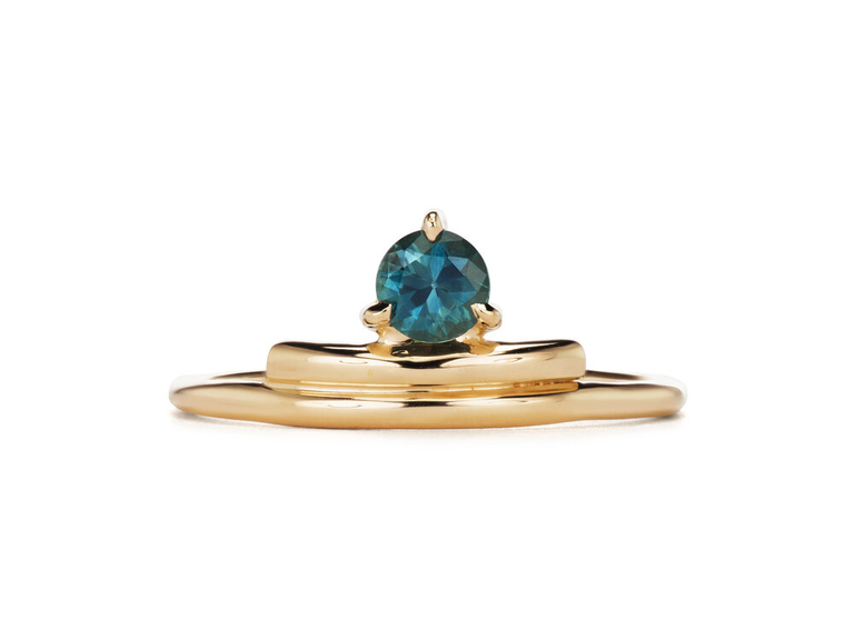 A double-banded yellow-gold ring with a round sapphire.