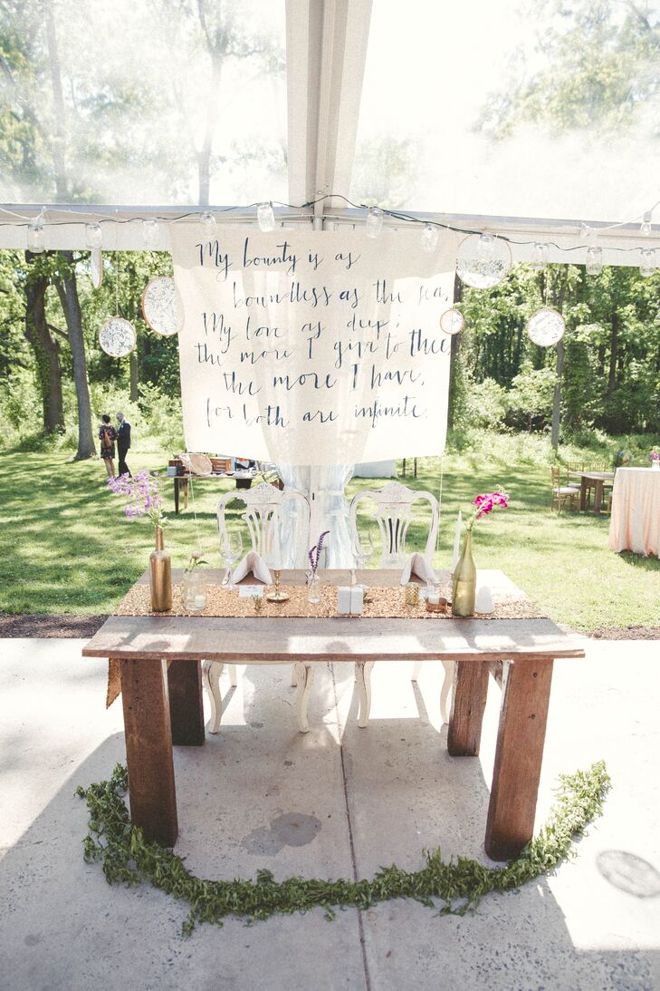 For their head table, Lauren and Paul got creative and introduced more of their own personal flair into the design. Instead of lace, they lined the wooden stand with a gold sequin runner and DIY gold bottle centerpieces. Lauren and her bridesmaids made the backdrop by writing out one of Paul’s favorite quotes from none other than “Romeo and Juliet.” Their guests also left a surprise by the newlywed's seating. “Our friends had a Polaroid camera that they snapped pictures with the whole night,” Lauren says. “As they took pictures, they scattered the photos on our table runner. By the time we sat down, we had a whole gallery of memories.”