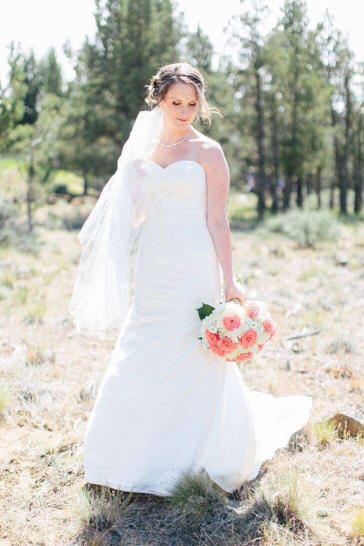 "I wanted a dress that was both elegant and simple, and the gown I found from Stella York was just that," Kellie says. "It was ivory and made of dolce satin, with ruching throughout the entire dress, and was accented with crystal beadwork in different areas. I always knew I wanted a sweetheart gown with a corset back, and a dress that was more fitted to my body."