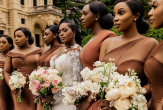 Group of bridesmaids posing with bride on wedding day
