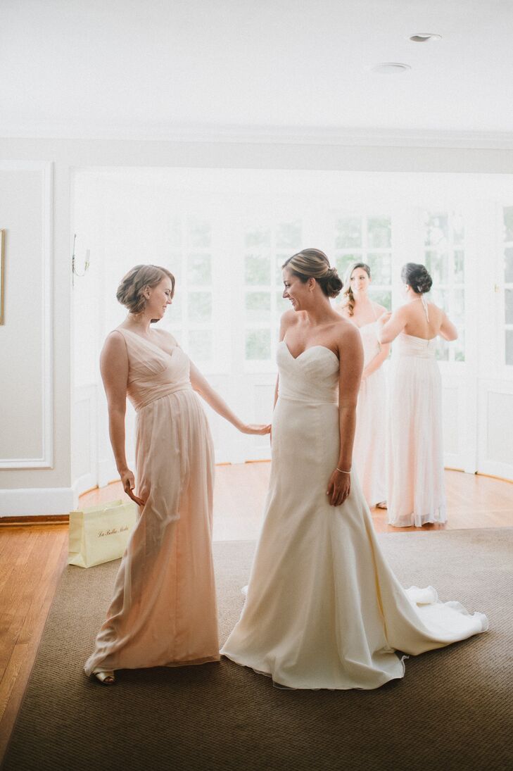 Beth wore an ivory, strapless Jim Hjelm gown with a lace and organza ruched sweetheart neckline bodice and an organza modifed A-line skirt with a chapel-length train and a jeweled belt.