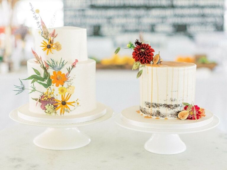 two wedding cakes decorated with pressed flowers