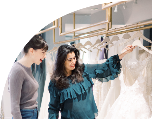 wedding couple browsing at white wedding dresses