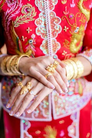 Bride in Chinese Qun Kwa Wedding Dress With Gold Jewelry