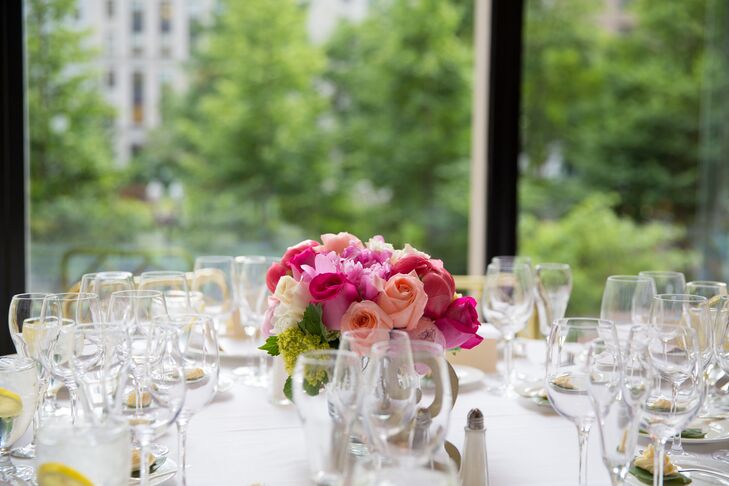 An arrangement of pink roses decorated the crisp white tables at the reception.