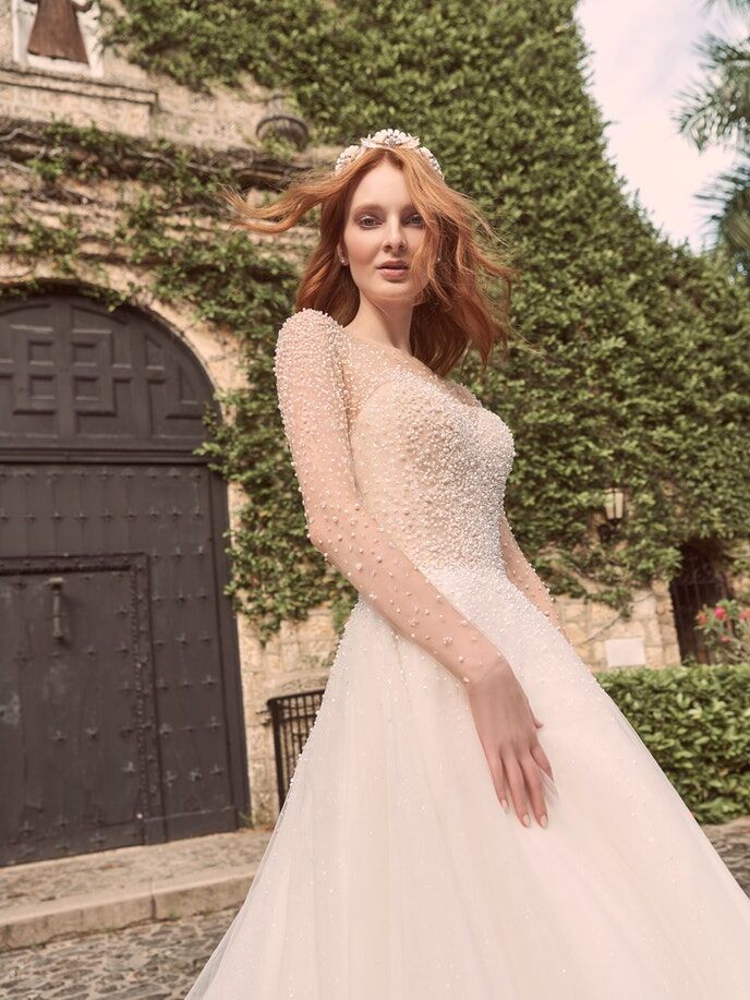 Long illusion sleeves and A-line skirt with pearl beading
