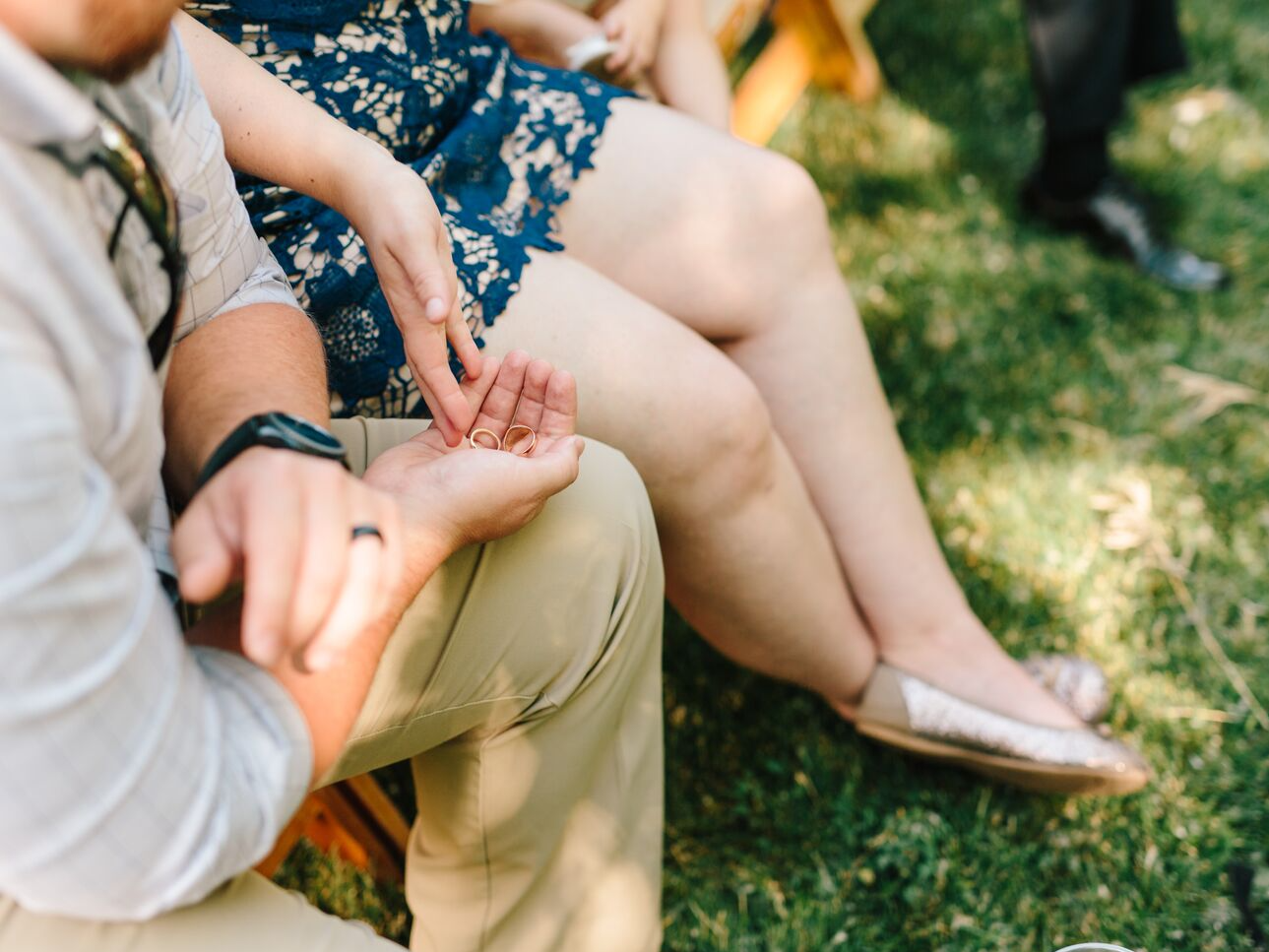 Couple holding wedding rings