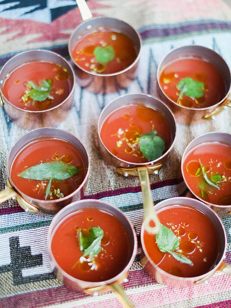 Wedding reception appetizer of mini gazpacho soups