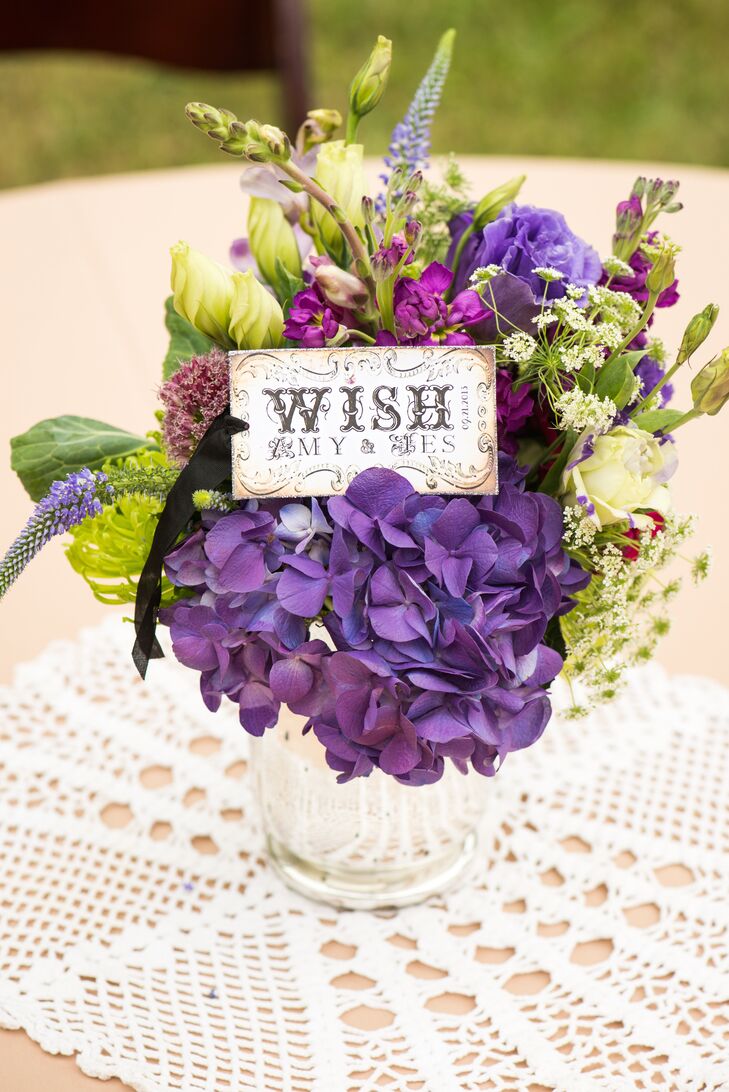 Amy and Jes's centerpieces included blooms of purple hydrangea and the couple's Wish motif.