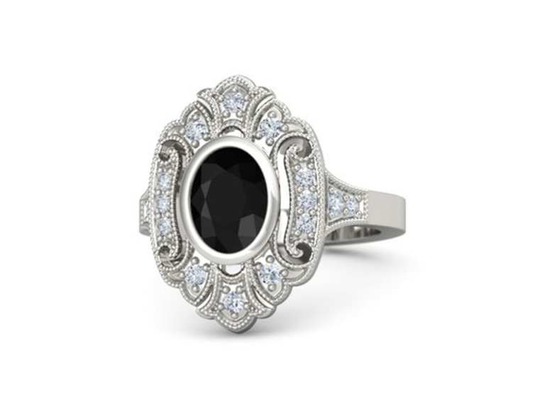 Round cut onyx center stone with vintage style diamond border on silver band