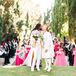 Grooms in Fashion-Forward, Custom Outfits Kiss at Outdoor Ceremony