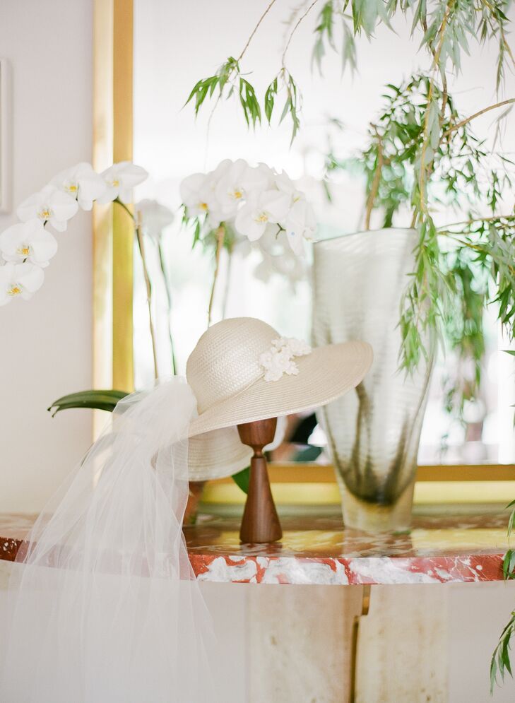 Sarah's mother's 1970s wedding outfit and the contemporary architecture of her childhood home inspired the bohemian-meets-Bauhaus wedding aesthetic. Sarah even wore a veiled, broad-brim hat instead of a veil, echoing the one her mother wore decades earlier.
