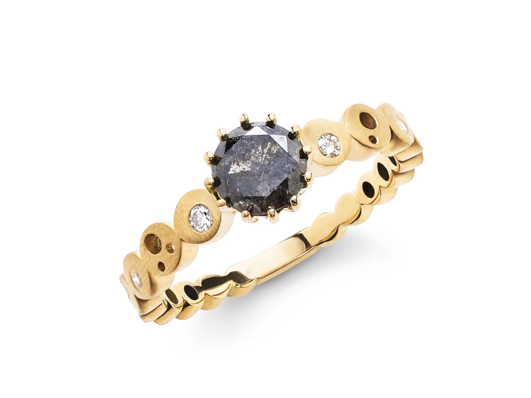 This engagement ring from Dana Bronfman is sure to bring the wow factor with its funky setting and black diamond at the center.