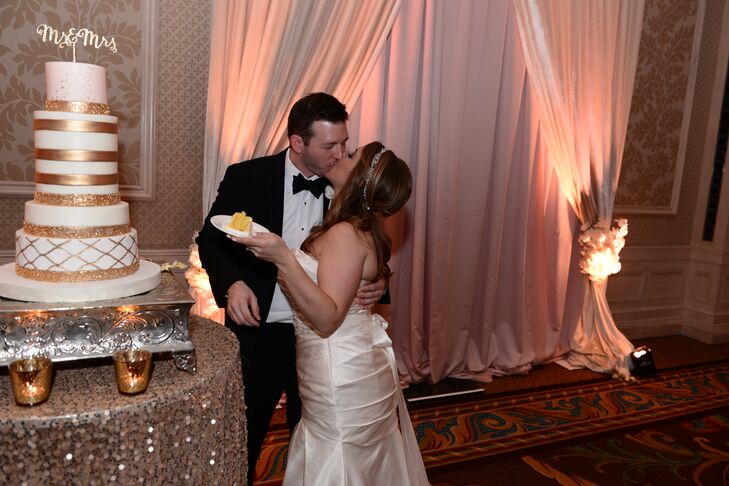 A towering cake, lined in gold and adorned with a laser-cut "Mr. & Mrs." topper rested atop a glistening, sequin tablecloth, bringing further elegance to the enchanted evening.
