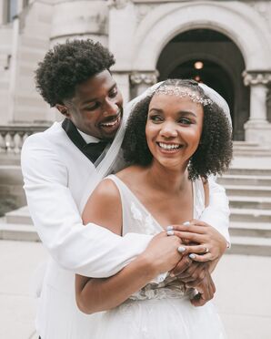 Couple Sharing a Hug While Wearing All-White Attire