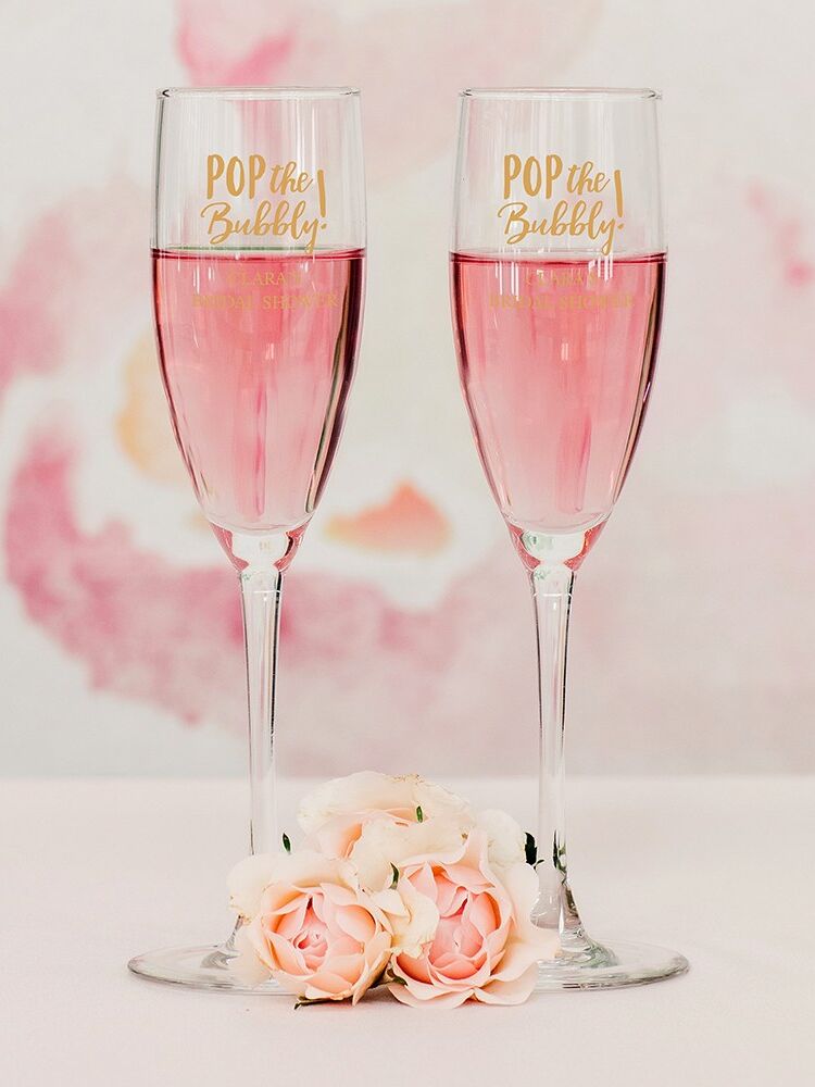 Champagne flutes that read "Pop the bubbly!"