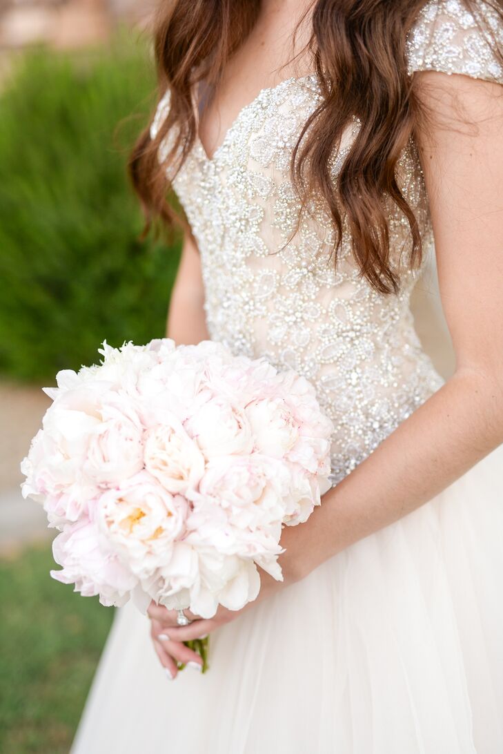 Brittney carried a round bouquet of blush peonies. The soft texture of the arrangement matched the beaded bodice of her ball gown.