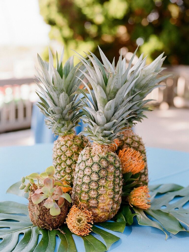 Pineapple coconut succulent wedding floral arrangements table centerpieces