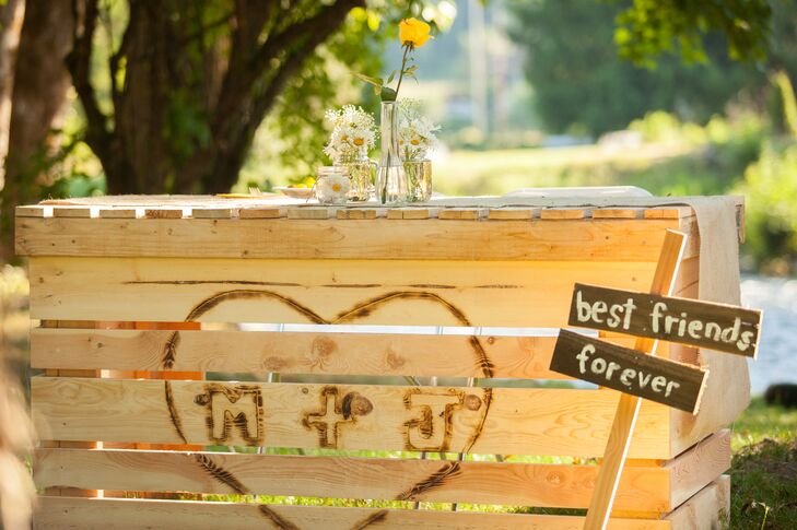 “Michael built a special table for the two of us to sit at,” says Jessica. “The front had a heart with our initials M + J in the center, burnt into the wood. It was beautiful, and we sat alone by the riverbank to eat our first meal together as a married couple.”