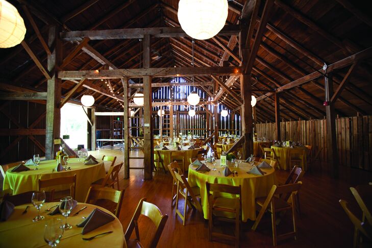The rustic barn was dressed up with yellow-linen-draped tables and gray napkins.
