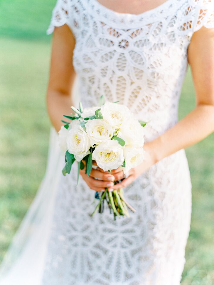 When it came to the bouquets, simplicity was essential. “I love the look of a petite arrangement and didn’t want to feel overwhelmed by an enormous bouquet,” Christine says. To accompany her Rue de Seine gown, Birds of a Flower pulled together a pint-size arrangement of ivory garden roses accented with bright green eucalyptus.