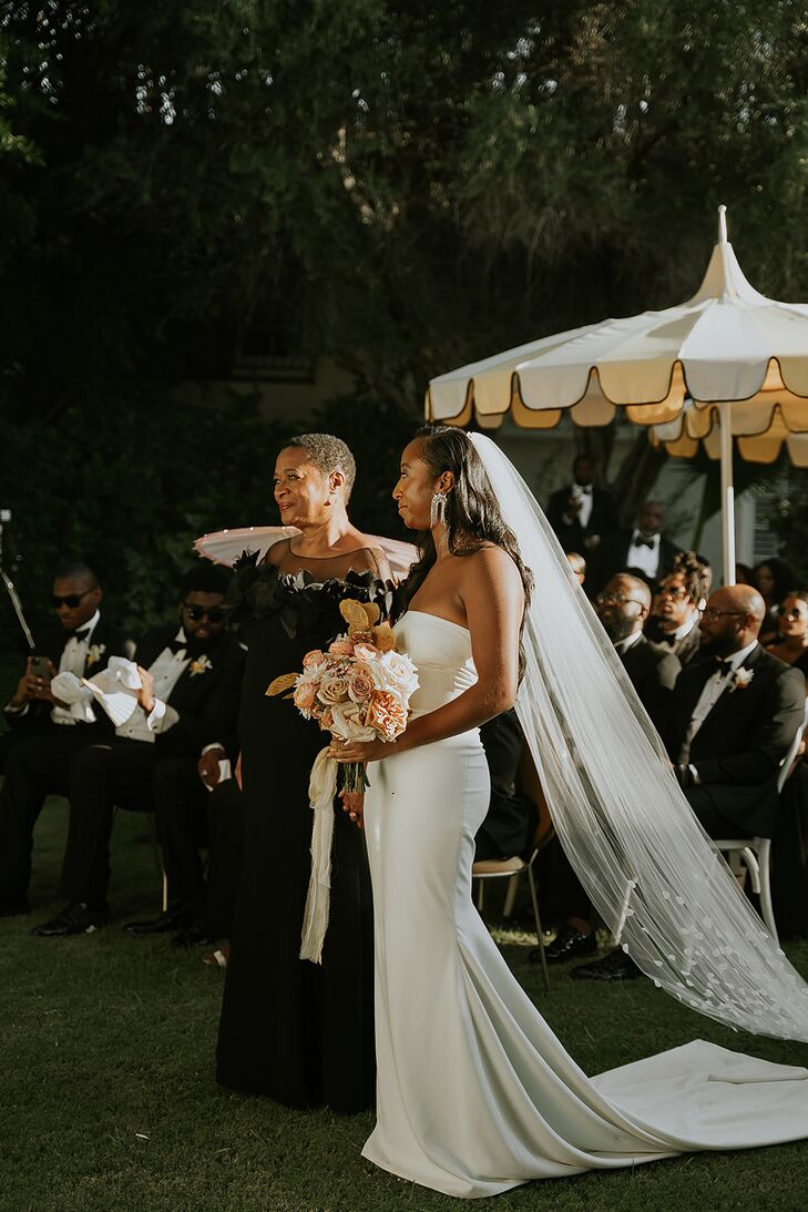 Bride's Mother in Black Gown With Bride in Sleek, Fitted Dress and Long Veil at Garden Altar