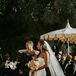 Bride's Mother in Black Gown With Bride in Sleek, Fitted Dress and Long Veil at Garden Altar