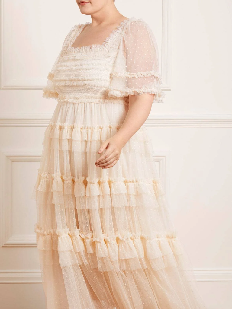 A model shows off this floaty and dreamy white lace dress.