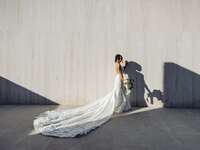 Bride wears an elegant wedding dress with a long train. 