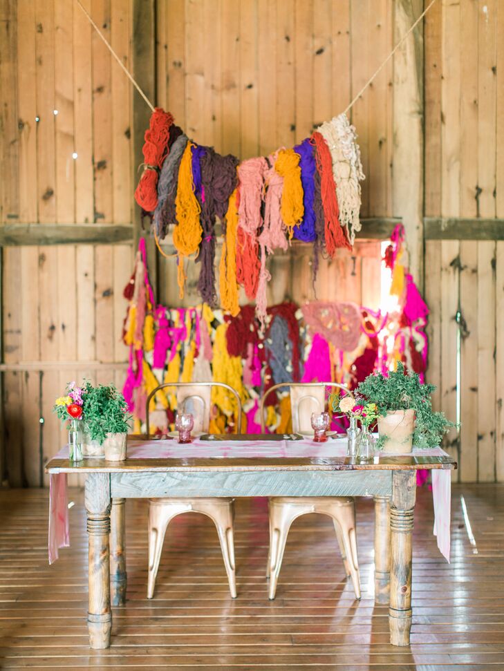 A large yarn display strung behind the sweetheart table added a homespun vibe to the couple's bold, bohemian-inspired decor. "We wanted our wedding to stand out from the norm and for our guests to feel an overwhelming sense of cheer and happiness," Courtney says.
