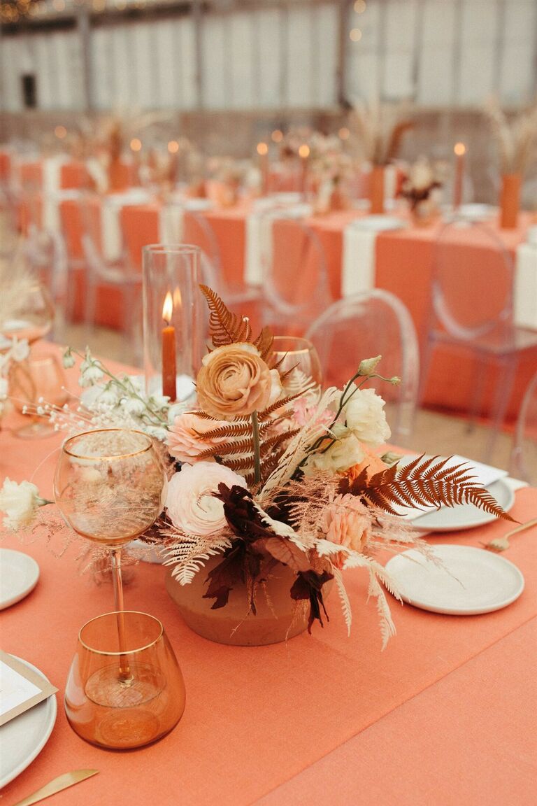 Orange tablescape with foliage-centric arrangements