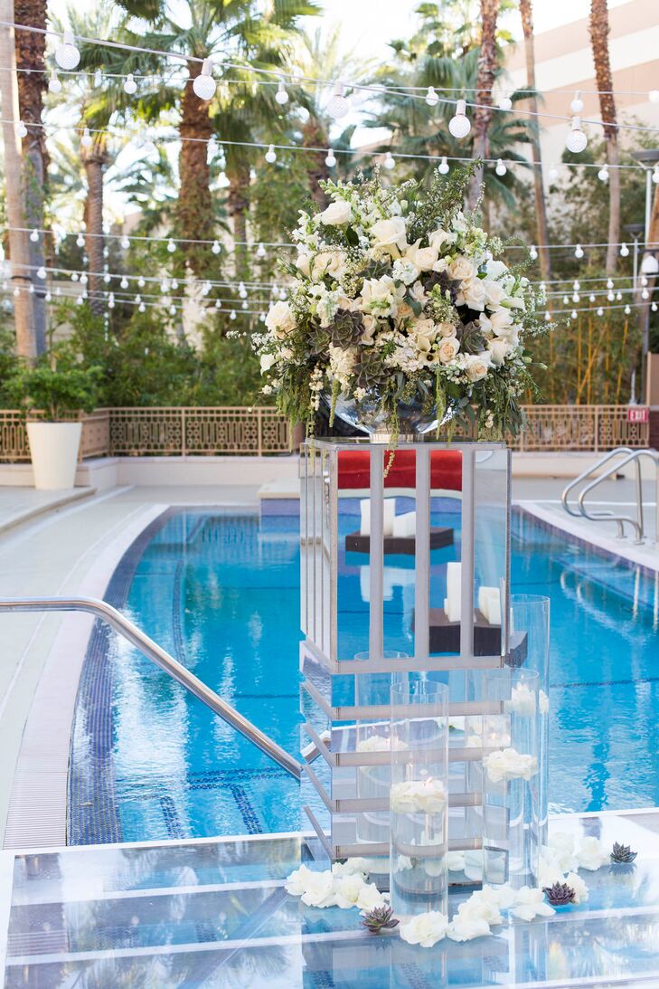 The interior space at Crimson featured red roses and black calla lilies. The exterior space, next to the pool, had peach and ivory roses and succulents were added to wooden planters on each table.