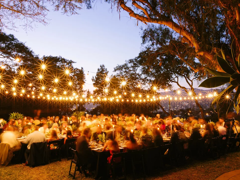 Art deco twinkle lights light up this outdoor reception space.