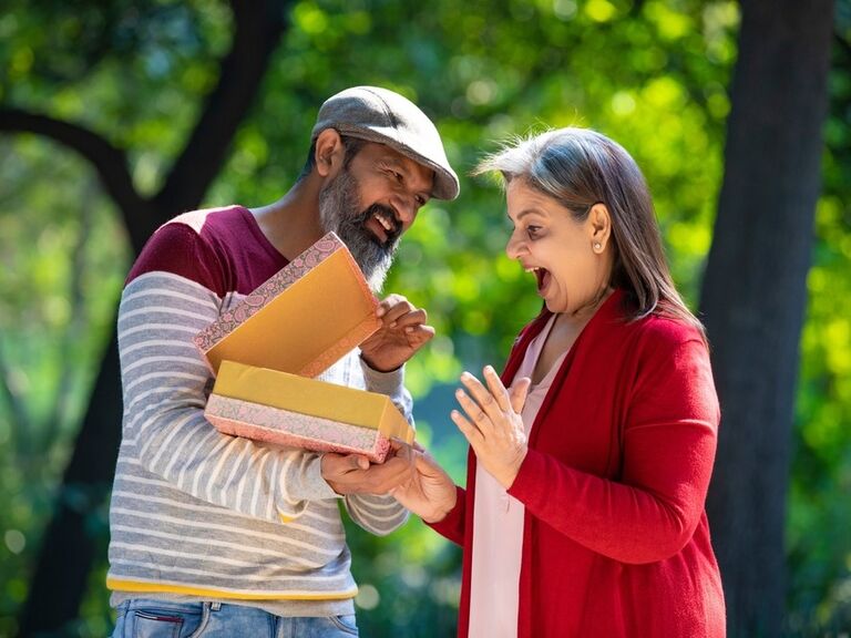 A couple exchange gifts with one another on their happy occasion