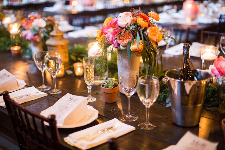 Molly and Boston paired low centerpieces with taller centerpieces to add some dimension to the space at Aria in Minneapolis, Minnesota. The towering ceilings and textured walls beautifully fit the  reception's rustic theme.