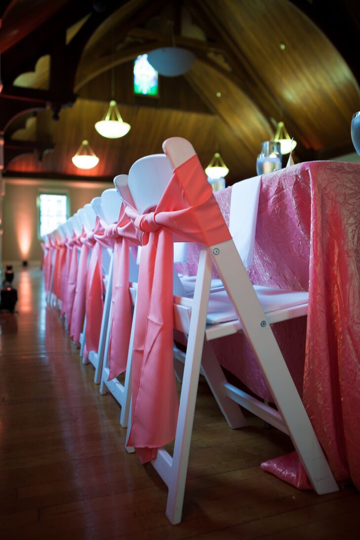 To bring their reception space to life, Mallory and Michael added bright pops of color wherever possible. Panels of pink fabric were tied into bows on each chair, matching the brightly-hued table linens.