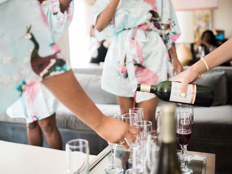 Bridesmaids getting ready and drinking pink champagne