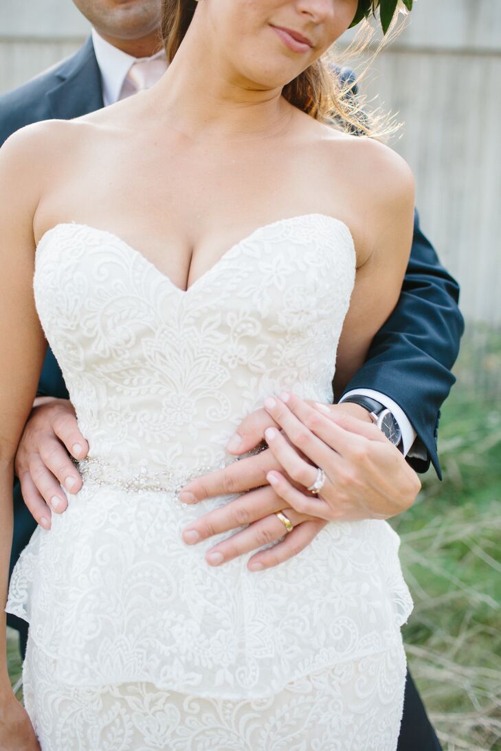 Claire fell in love with this Allure Couture dress the moment she put it on. She loved the strapless sweetheart neckline, the stunning lace peplum and the Swarovski crystal belt at the natural waist. It also had a chapel-length train that she had bustled in a French and traditional combination at the reception at Historic Riverside Building in Rochester, Minnesota.