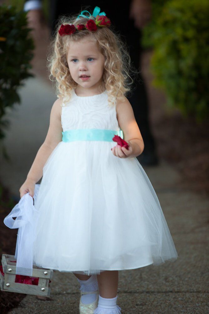 The little flower girl sported the bride and groom's bright blue and red color palette in her accessories.