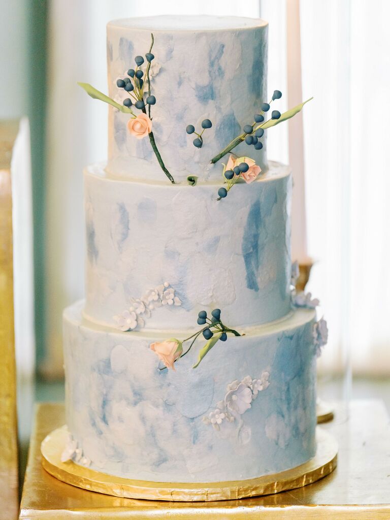 three tier blue fondant wedding cake with gold foil cake board
