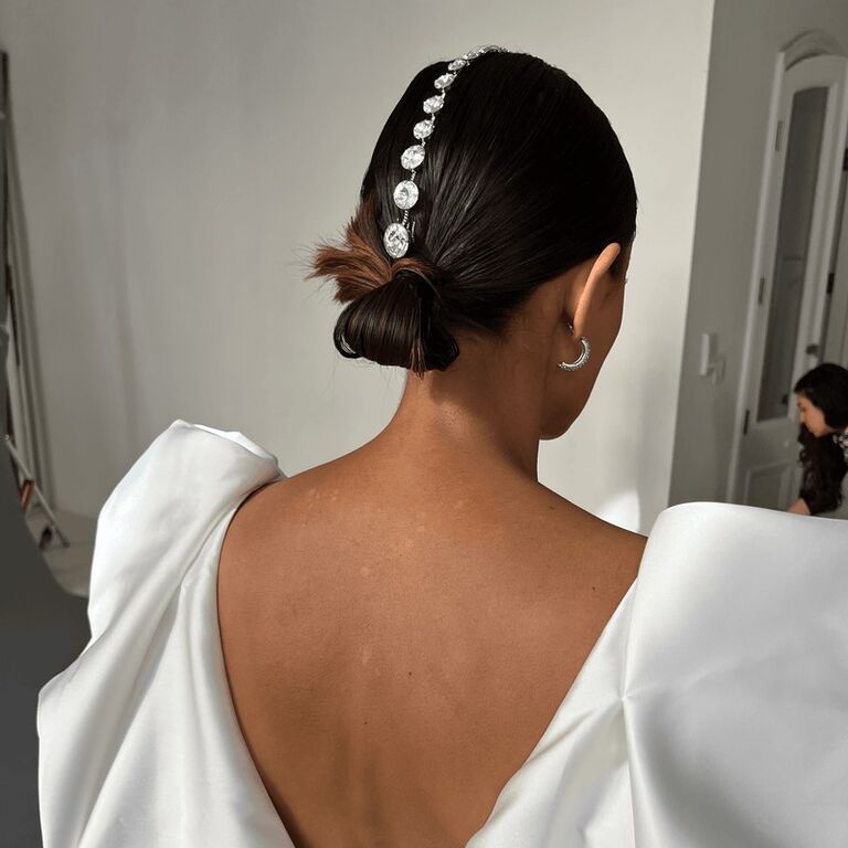 Model wears a bedazzled crystal hairpiece. 